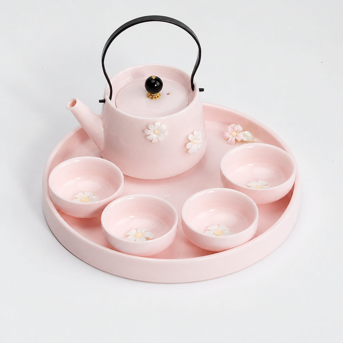 Blush pink floral tea set with teapot, four shallow Zen flower cups, and round tray