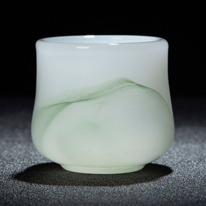 A translucent jade-like cup with a pale green wave pattern, shown on a dark textured surface with a black background. A red and white text banner is at the bottom with Chinese text and dimensions.