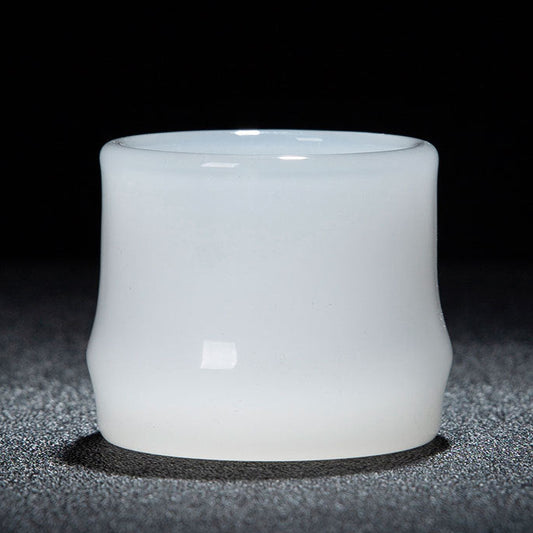 A white translucent glass cup with a smooth matte finish, photographed against a dark background. A red and white text banner is visible at the bottom with Chinese dimensions and capacity details.