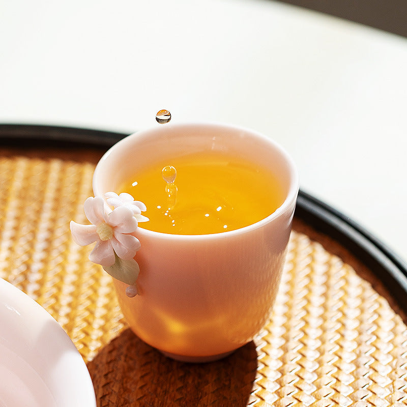 Blush pink floral gongfu teacup filled with golden tea