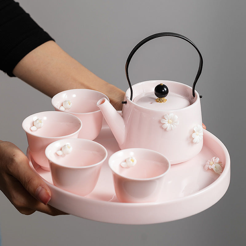Blush pink floral gongfu tea set being carried on its matching round tray