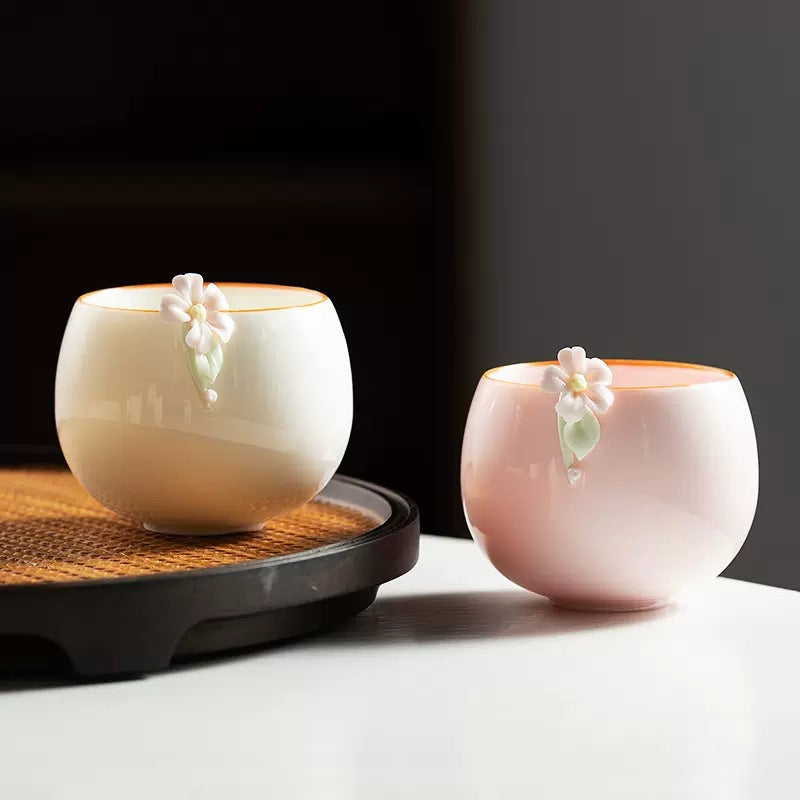 Pink and moon-white floral ceramic gongfu teacups displayed together